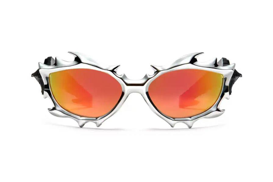 Gentle Monster x Tekken 8 Inferno goggles displayed on a dark background, showcasing red mirrored lenses and horn-like silver frames Gentle Monster