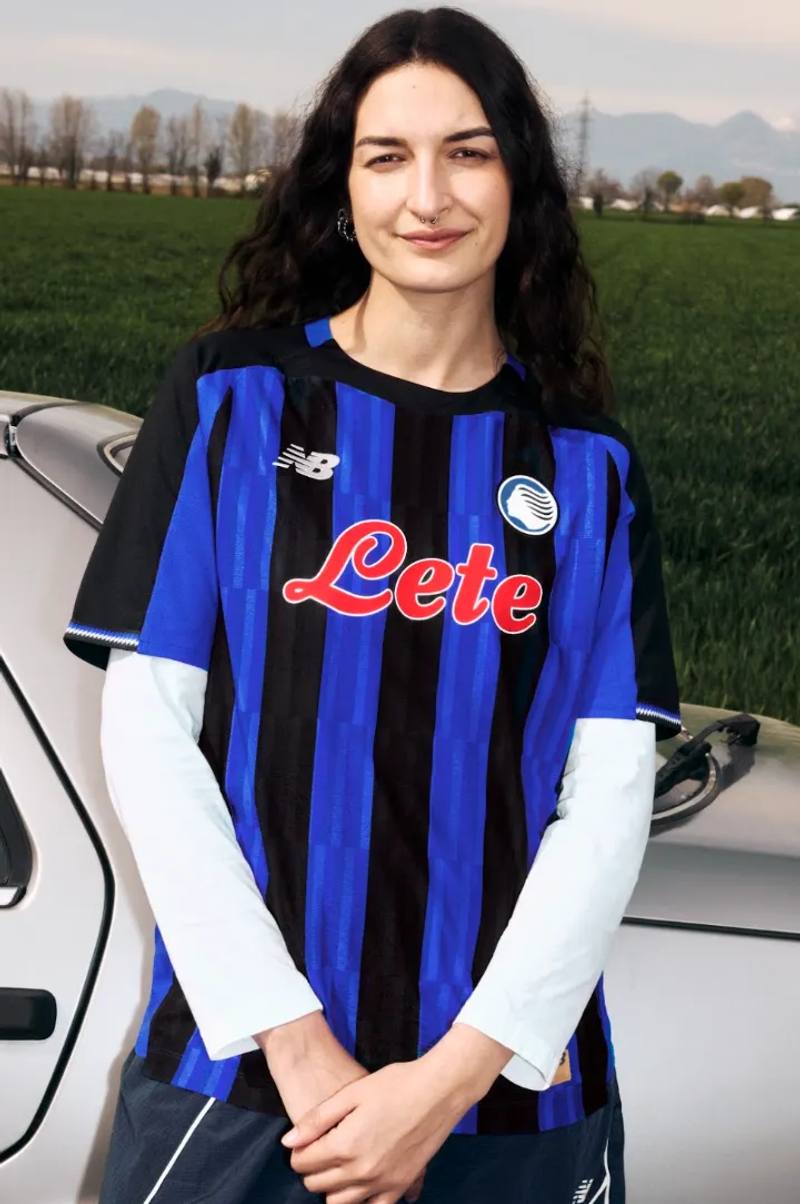 An image of the new Atalanta BC home jersey for the 2026/27 season, featuring Oasis Blue and black vertical stripes with metallic accents.