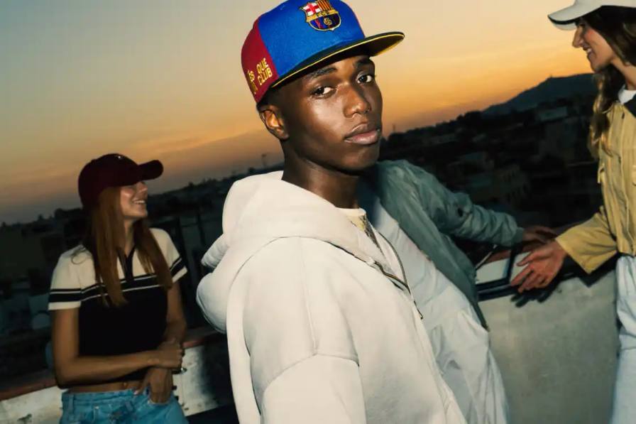 BARCELONA PARTNERS WITH NEW ERA FOR HEADWEAR LINE FC Barcelona announces headwear partnership with New Era, releasing collection featuring multiple cap styles in club colors with special commemorative edition.
