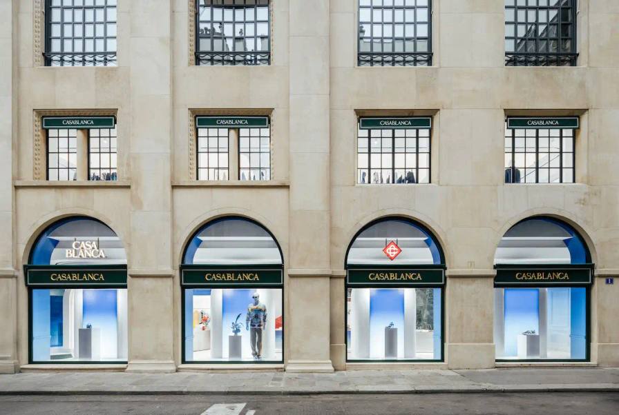image of Fashion brand Casablanca has opened its first flagship store in Paris on the prestigious Rue du Faubourg Saint-Honoré. The three-floor boutique features Haussmannian architecture with design elements inspired by tennis courts, ancient Greece, and futurism. For founder Charaf Tajer, who grew up in Paris's Belleville district, the opening represents a meaningful homecoming and milestone for the luxury streetwear brand.