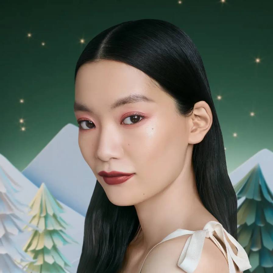 PRADA BEAUTY HOLIDAY MAKEUP LOOKS Article details two holiday makeup tutorials from Prada Beauty, one emphasizing eyes and one emphasizing lips, with step-by-step product applications.