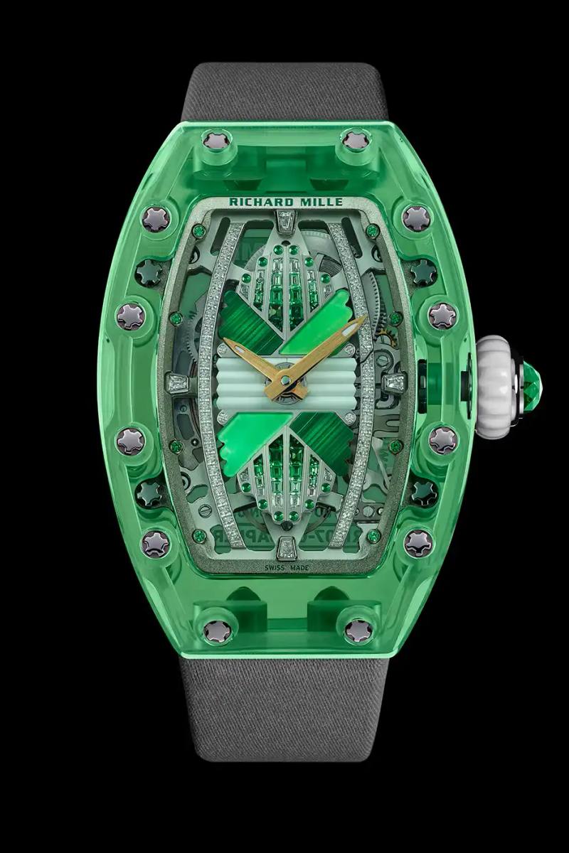 Richard Mille Richard Mille RM 07-02 luxury watch with a transparent colored sapphire crystal case. The watch features a geometric pattern dial set with precious stones including diamonds, sapphires, and ornamental stones. The skeletonized automatic movement is visible through the translucent case, showing intricate mechanical details and gold components.