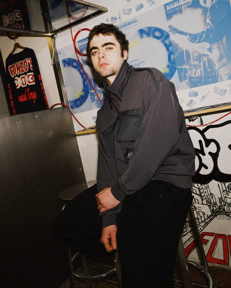 image of Lennon Gallagher, featuring a Q&A format discussion about his modeling work with Napapijri, his band activities, daily routines, and personal influences including David Bowie. The article reveals his casual approach to life, balancing music practice with modeling, and his preference for a laid-back lifestyle. shoot by Matteo Vetrano