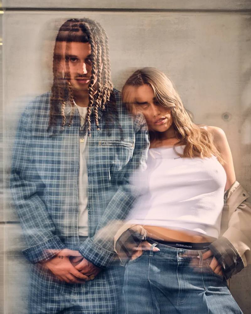 An IMAGE detailing the GUESS JEANS Pre Fall 2026 fashion campaign featuring musical artists Sayf and Clara in Milan.