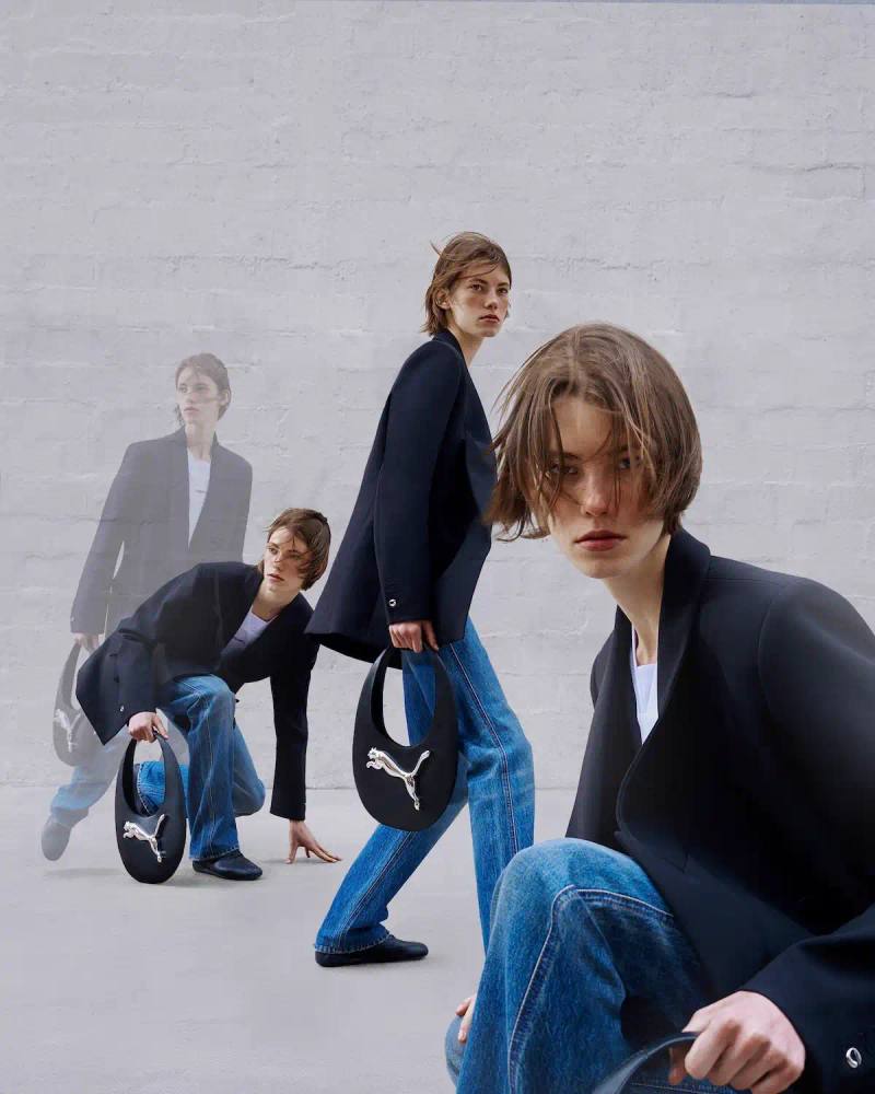 Puma/Coperni The image shows the PUMA and Coperni collaborative collection. It includes an asymmetrical gown and top made from sustainable technical fabric, a hoodie with cat ears, co-branded t-shirts, and reinterpreted versions of the Swipe Bag and Speedcat and 90SQR sneakers. The collection is designed to merge fashion, sportswear, and technology.