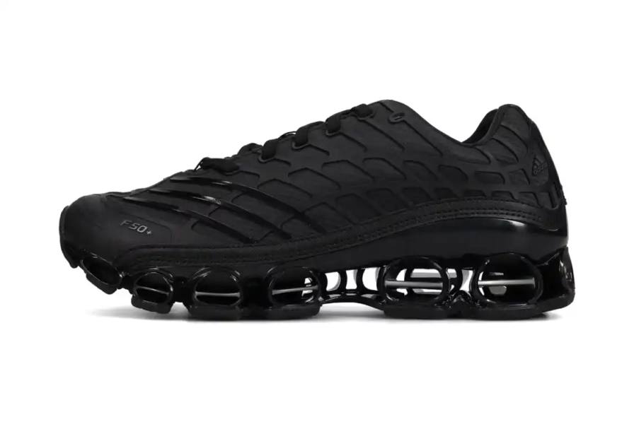 adidas releases Megaride F50 sneaker in Core Black colorway with wavy grid overlays and hollowed-out sole on January 1, 2026 for $180 USD.