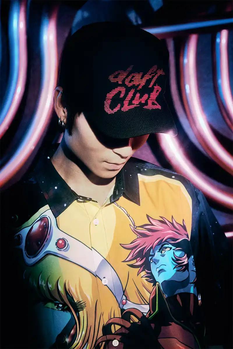 DAFT PUNK TEAMS UP WITH PLEASURES FOR NEW CAPSULE image about fashion collaboration between electronic music duo Daft Punk and streetwear brand PLEASURES. Features clothing and accessories incorporating the musicians' robot helmet imagery, album artwork, and references to their music videos and films. Collection includes hoodies, jackets, jeans, and accessories available July 16, 2025.