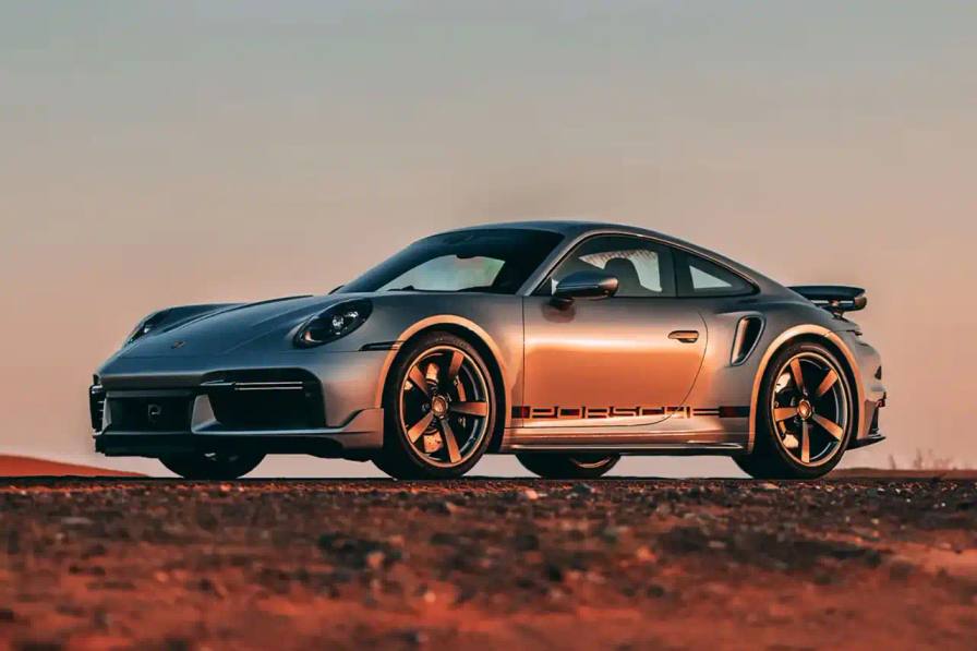 Rm Sotheby's A unique Porsche 911 "Turbo Remastered" model has emerged, paying tribute to the iconic 1974 Turbo prototype. This one-off vehicle features a gleaming GT Silver exterior with classic Fuchs-style wheels, evoking the original design. Inside, the two-tone Lipstick Red and black leather interior is complemented by retro-inspired green gauges and tartan accents. Under the hood, the modern 911 Turbo packs over 570 horsepower, rocketing from 0-60 mph in 2.8 seconds. With just 35 kilometers on the odometer, this pristine Porsche homage will cross the auction block on November 20th, estimated to fetch up to $430,000.