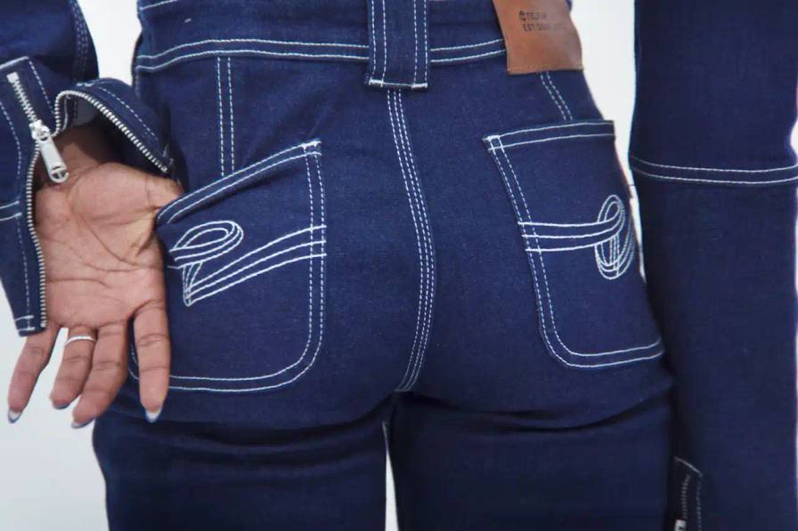 TELFAR LAUNCHES EXPANSIVE DENIM COLLECTION IN SOHO Telfar's new Infinity Collection, highlighting the brand's innovative approach to denim design. The collection features versatile, unisex garments with transformative silhouettes, priced between $190-$485. Key points include multipurpose clothing, unique cut-out designs, and an unconventional retail strategy at the Soho flagship store. The text provides detailed information about the collection's aesthetic, pricing, and availability for readers using screen readers or assistive technologies.