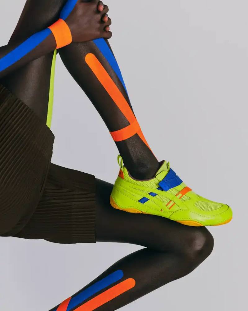 ASICS AND MIYAKE DESIGN STUDIO COLLABORATION DEBUTS ASICS partners with Miyake Design Studio to create HYPER TAPING sneakers, featuring elastic band construction inspired by athletic taping and a wrestling shoe outsole adapted for daily wear.