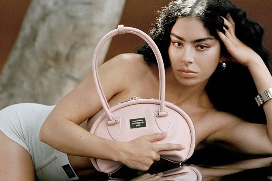 The Acne Studios Spring/Summer 2025 campaign features singer-songwriter Charli XCX wearing key pieces from the collection, including coated iridescent and painted trompe-l'oeil denim styles, as well as the new season's Multipocket and Bowlina bags. The collaboration highlights Charli XCX's longstanding relationship with the brand and her ability to seamlessly blend underground and mainstream influences.