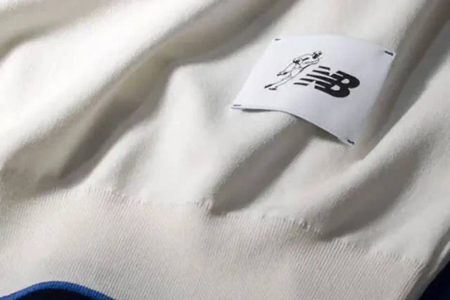 OHTANI COLLECTION: NEW BALANCE DROPS JAPAN-MADE TEES Article about New Balance's collaboration with baseball player Shohei Ohtani on premium T-shirts made in Japan. Contains information about product specifications, pricing, manufacturing details, and availability. Text includes technical details about cotton yarn processing and traditional Japanese textile methods.