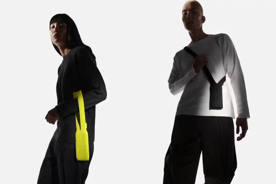 ISSEY MIYAKE AND APPLE LAUNCH IPHONE POCKET A 3D-knitted textile iPhone holder in a rectangular shape with ribbed pleated structure, available with short wrist strap or long crossbody strap in multiple colors, designed by Issey Miyake and Apple.