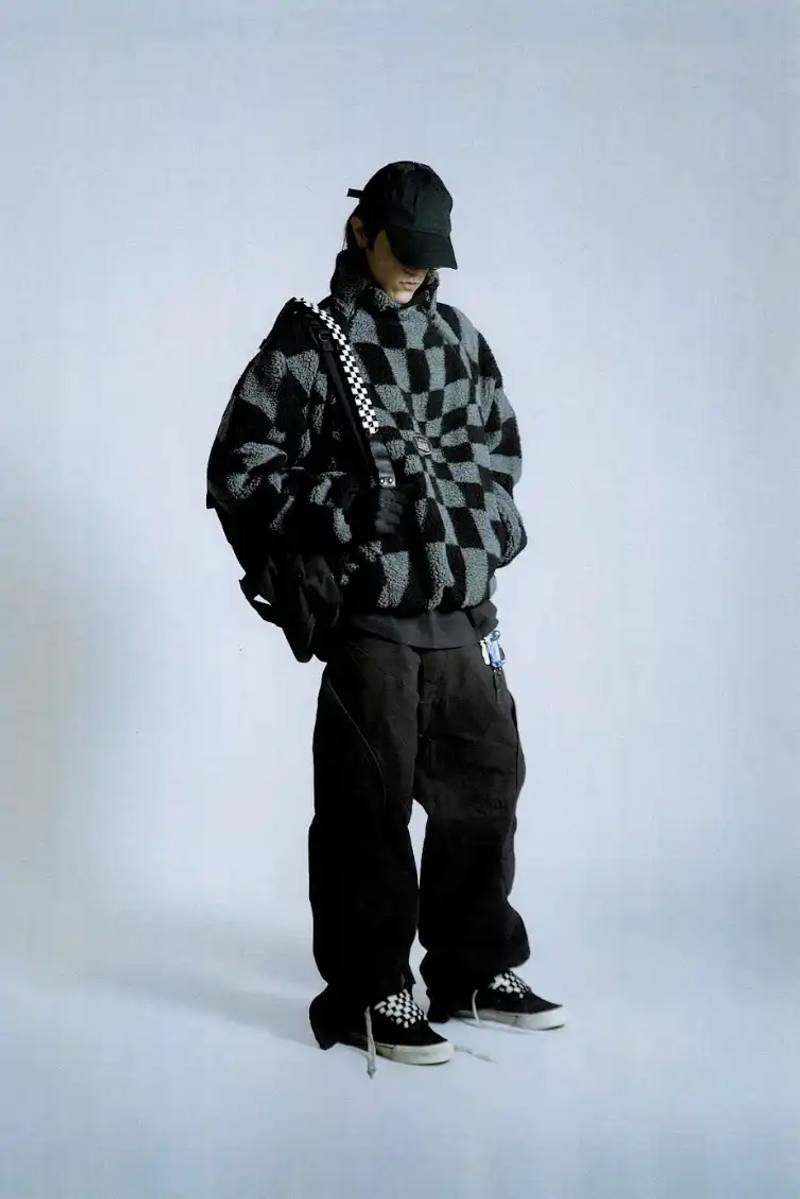 image about the collaboration between Vans and Slam Jam on a new clothing line called Act of Disagreement, featuring oversized hoodies, fleece jackets, and cropped pants.