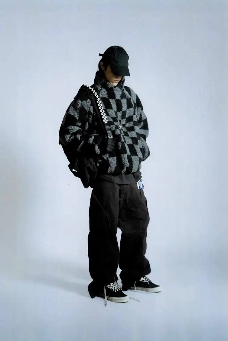 VANS AND SLAM JAM LAUNCH ACT OF DISAGREEMENT image about the collaboration between Vans and Slam Jam on a new clothing line called Act of Disagreement, featuring oversized hoodies, fleece jackets, and cropped pants.