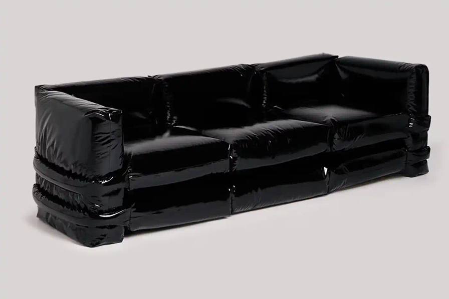 KASSL EDITIONS PILLOW SOFA GETS GLOSSY BLACK UPDATE image about furniture designers Muller Van Severen relaunching their Pillow Sofa design in a new glossy black fabric option.