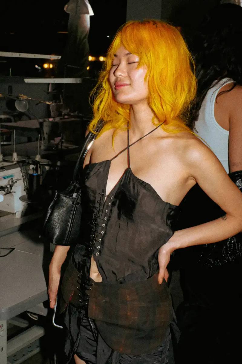 MIISTA SS26 COMBINES TECHNO MUSIC AND GARMENT MENDING An image about on the Miista Spring/Summer 2026 launch in Los Angeles. The text details the music performances and the live garment mending station at The Evans Group factory.