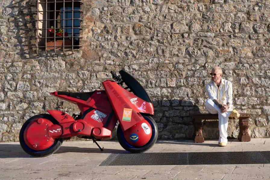 J BALVIN UNVEILS CUSTOM ELECTRIC BIKE image about Colombian reggaeton artist J Balvin's custom electric motorcycle collaboration. Contains technical specifications, design details, and information about the development process between his creative studio VVT and manufacturer DAB Motors.