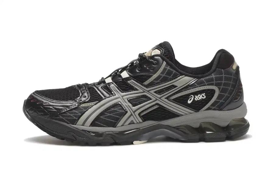 ASICS GEL-NIMBUS 10.1 sneaker in black mesh with grey metallic overlays, featuring Tiger Stripes branding and dual-layer EVA midsole.