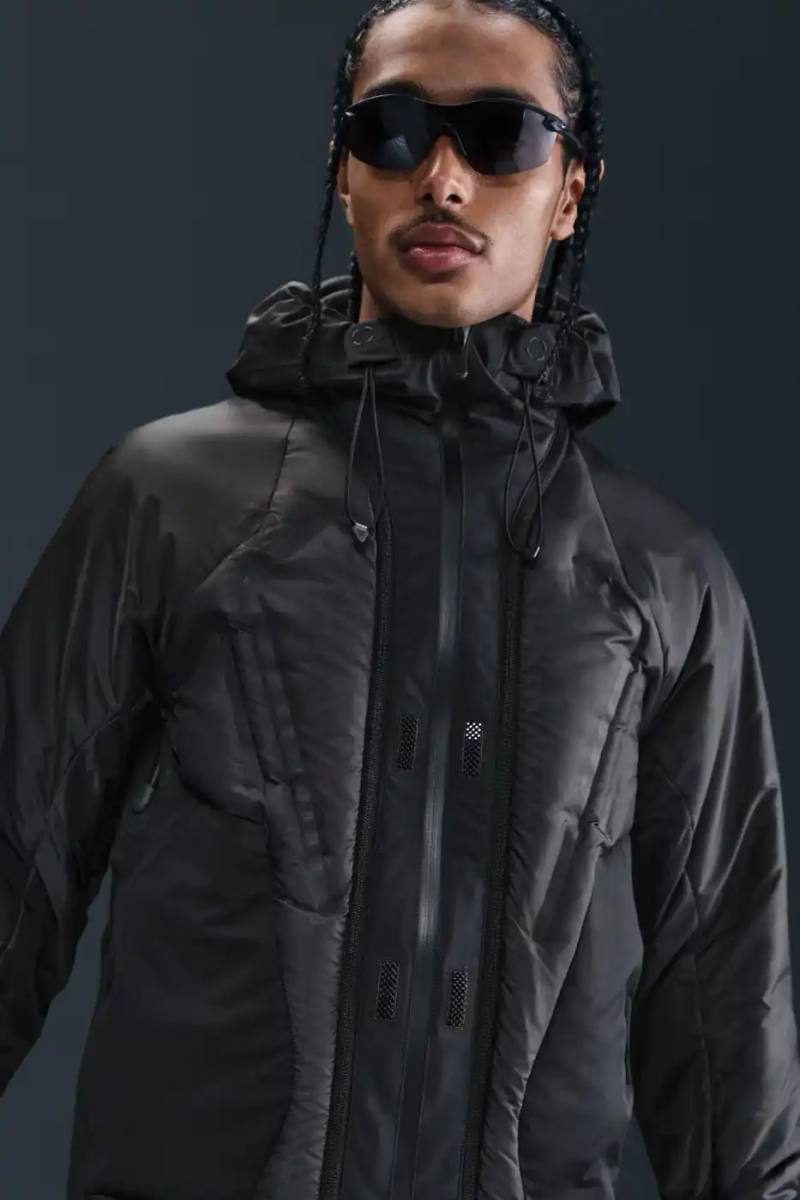NIKE BREATHES NEW LIFE INTO ICONIC INFLATABLE JACKET Nike ISPA Adapt Sense Air inflatable jacket shown in black and chestnut brown colorways with integrated pump system and convertible design features.