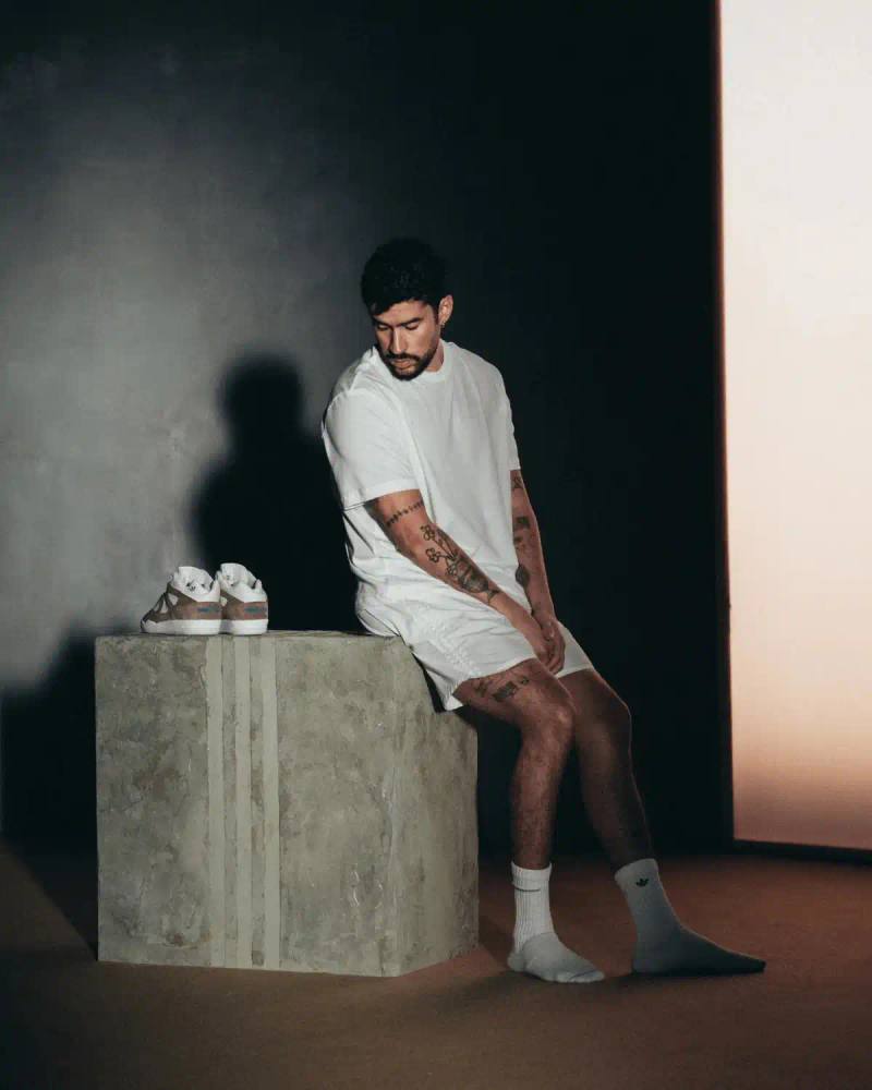 BAD BUNNY DEBUTS FIRST SIGNATURE SHOE WITH ADIDAS Bad Bunny launches his first signature sneaker with adidas Originals called BadBo 1.0, a mid-cut design in brown and white colorway that sold out in limited 1994-pair release.