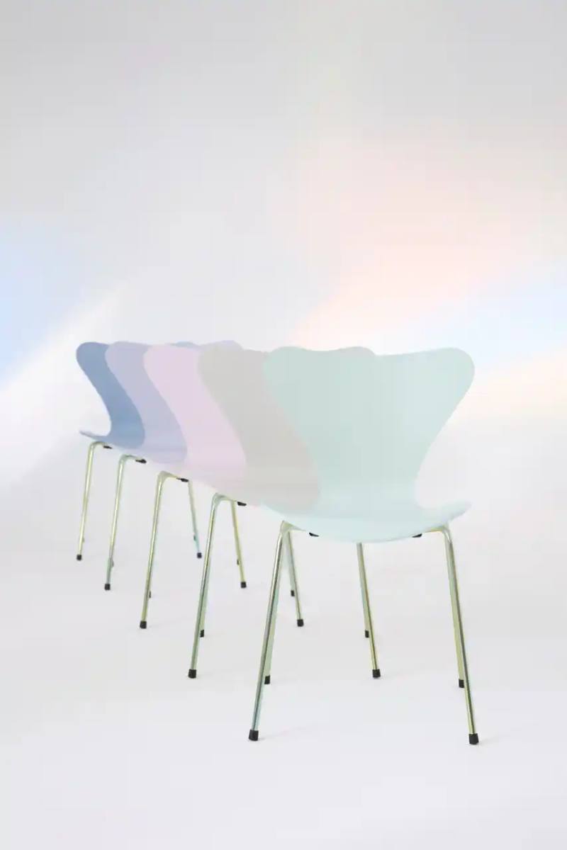 Fritz Hansen A side view of the Fritz Hansen Series 7 chair in a soft color palette, showcasing its signature curved plywood seat and chrome legs. The chair sits against a minimalist background, highlighting its elegant design and iridescent leg finish. The image captures the chair's iconic silhouette, demonstrating the timeless mid-century modern aesthetic created by Arne Jacobsen in 1955. These descriptions provide a concise, informative summary for search engines and a detailed visual description for users relying on screen readers or alternative text, respectively. The meta description includes key elements like the brand, product, anniversary, and unique collection feature, while the accessibility description offers a rich, descriptive narrative of the chair's visual characteristics.