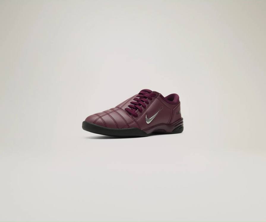 Nike Nike Total 90 sneaker collection featuring six colorways: burgundy with silver accents, bright orange, white with black and gold details, glossy black, metallic gold with green accents, and classic silver with red. Also shown are two Gato indoor boots in metallic silver and gold finishes. All shoes displayed against a white background.