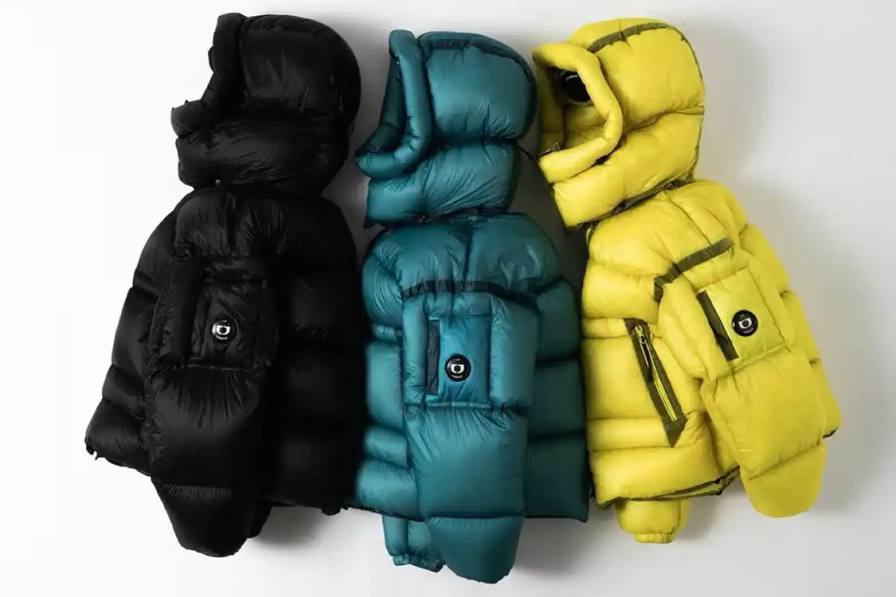 image detailing the Spring/Summer 2026 collaboration between C.P. Company and One Block Down, featuring rapper 22 Simba and technical outerwear descriptions.