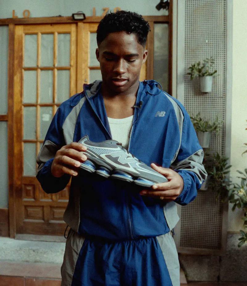 ENDRICK STARS IN NEW BALANCE ABZORB 2000 CAMPAIGN The header image displays Endrick standing on a street corner in Madrid while holding a grey and blue New Balance ABZORB 2000 sneaker. He wears a blue athletic tracksuit and looks down at the shoe in his hands.