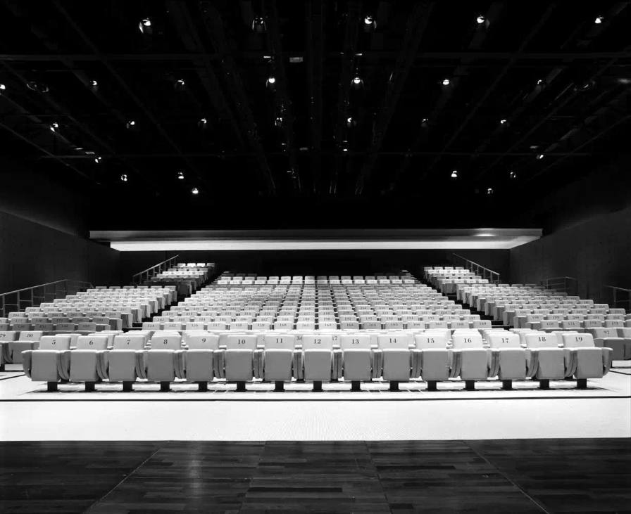 image about Giorgio Armani's theater venue in Milan, created through collaboration with Japanese architect Tadao Ando by transforming a former industrial building into a cultural space for fashion shows and events.