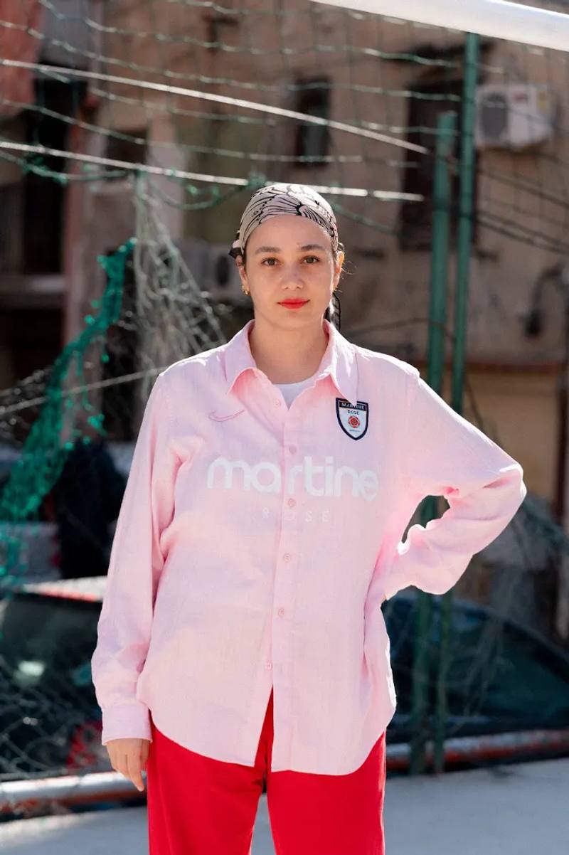 image of interview profile explores the professional journey of Naomi Accardi, an Italian editorial consultant who specializes in the intersection of football, fashion, and creative storytelling. The article details her career progression, from working with brands like Nike and Adidas to founding innovative projects like systemarosa and RISERVE. Accardi discusses her personal experiences in the football and fashion industries, her relationship with her father, and her approach to creativity, offering insights into her multifaceted professional identity and passion for sports culture.