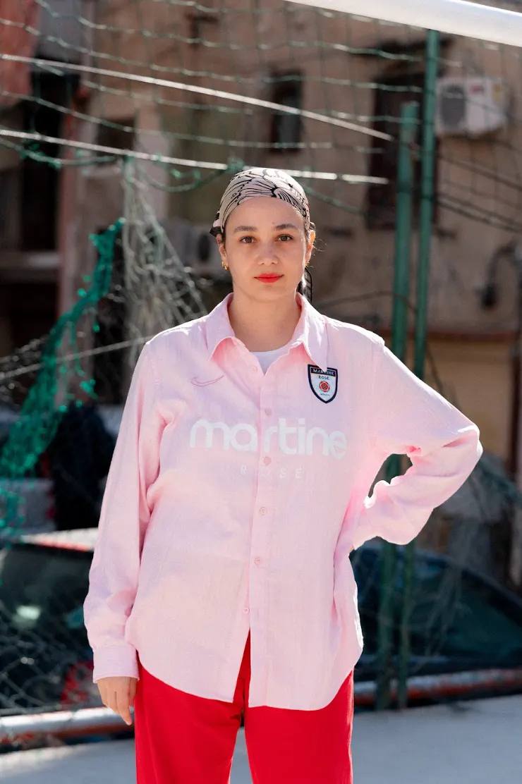 NAOMI ACCARDI: FOOTBALL & FASHION image of interview profile explores the professional journey of Naomi Accardi, an Italian editorial consultant who specializes in the intersection of football, fashion, and creative storytelling. The article details her career progression, from working with brands like Nike and Adidas to founding innovative projects like systemarosa and RISERVE. Accardi discusses her personal experiences in the football and fashion industries, her relationship with her father, and her approach to creativity, offering insights into her multifaceted professional identity and passion for sports culture.