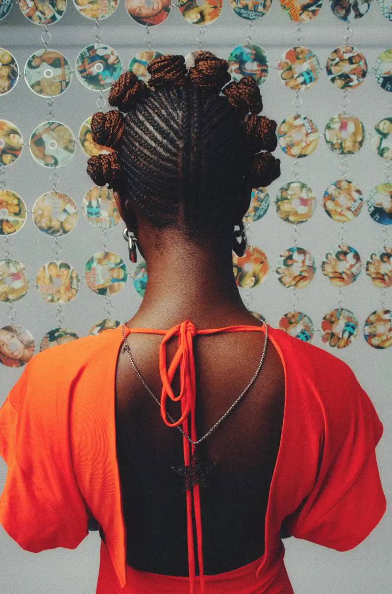 Moving from Lagos to England shaped her perspective on community and confidence.