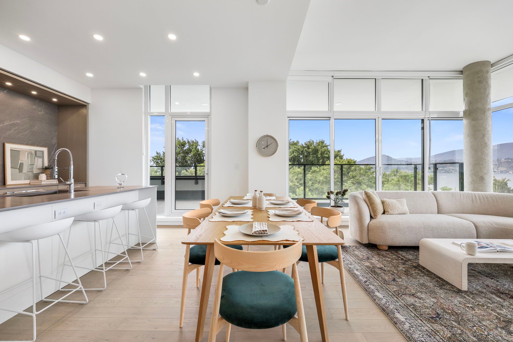 Open concept kitchen, dining, and living room on sunny day