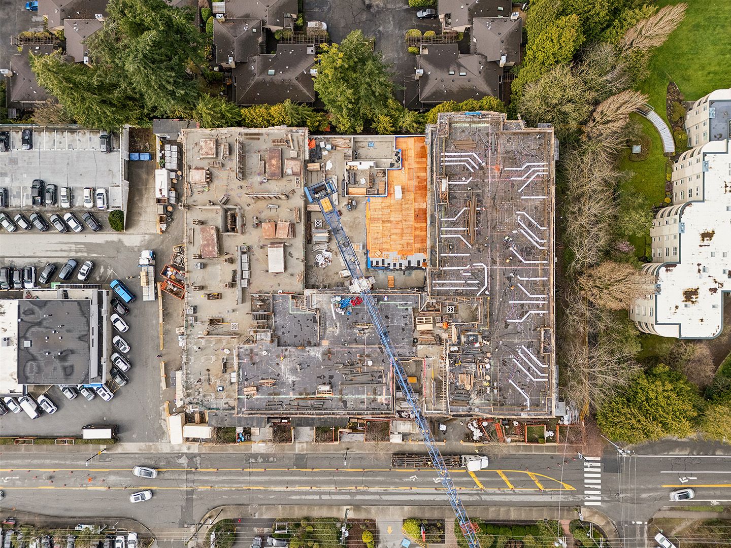 Bird's eye view of construction progress - crane, HVAC ducting, party walls and courtyard definition visible on site