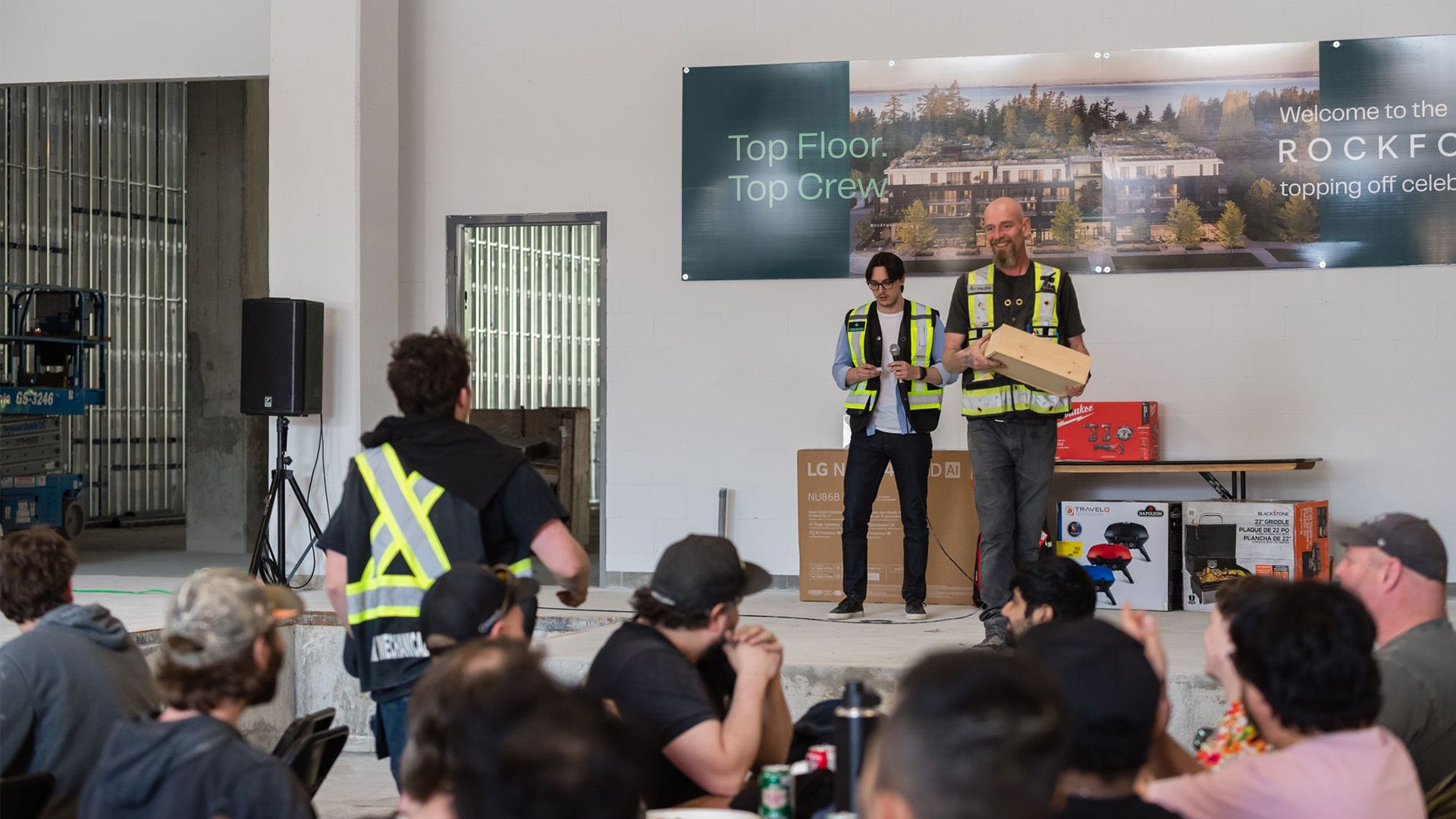 Construction worker walking to receive prize at team event