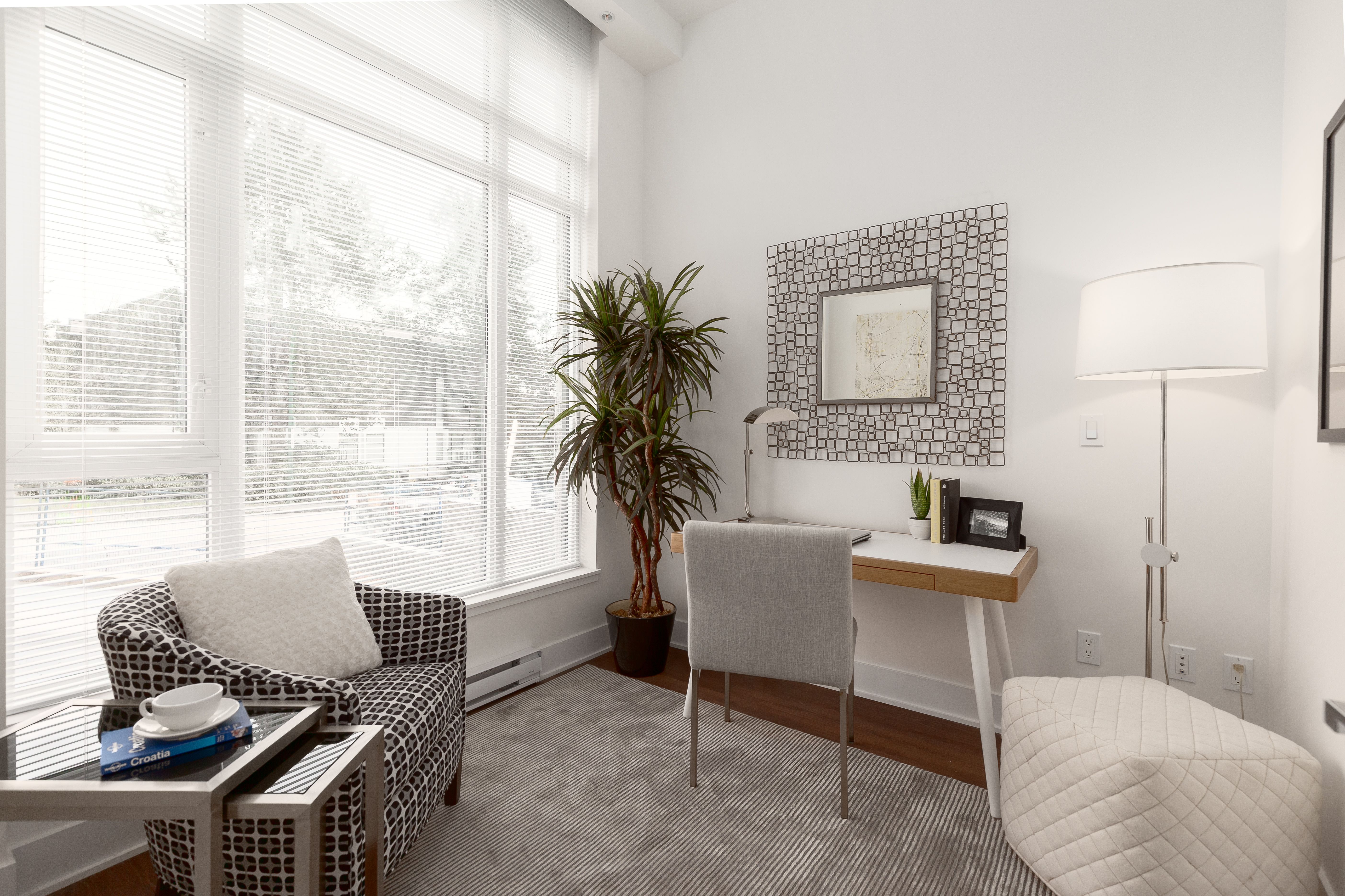 Living room with floor-to-ceiling windows in Everlea unit