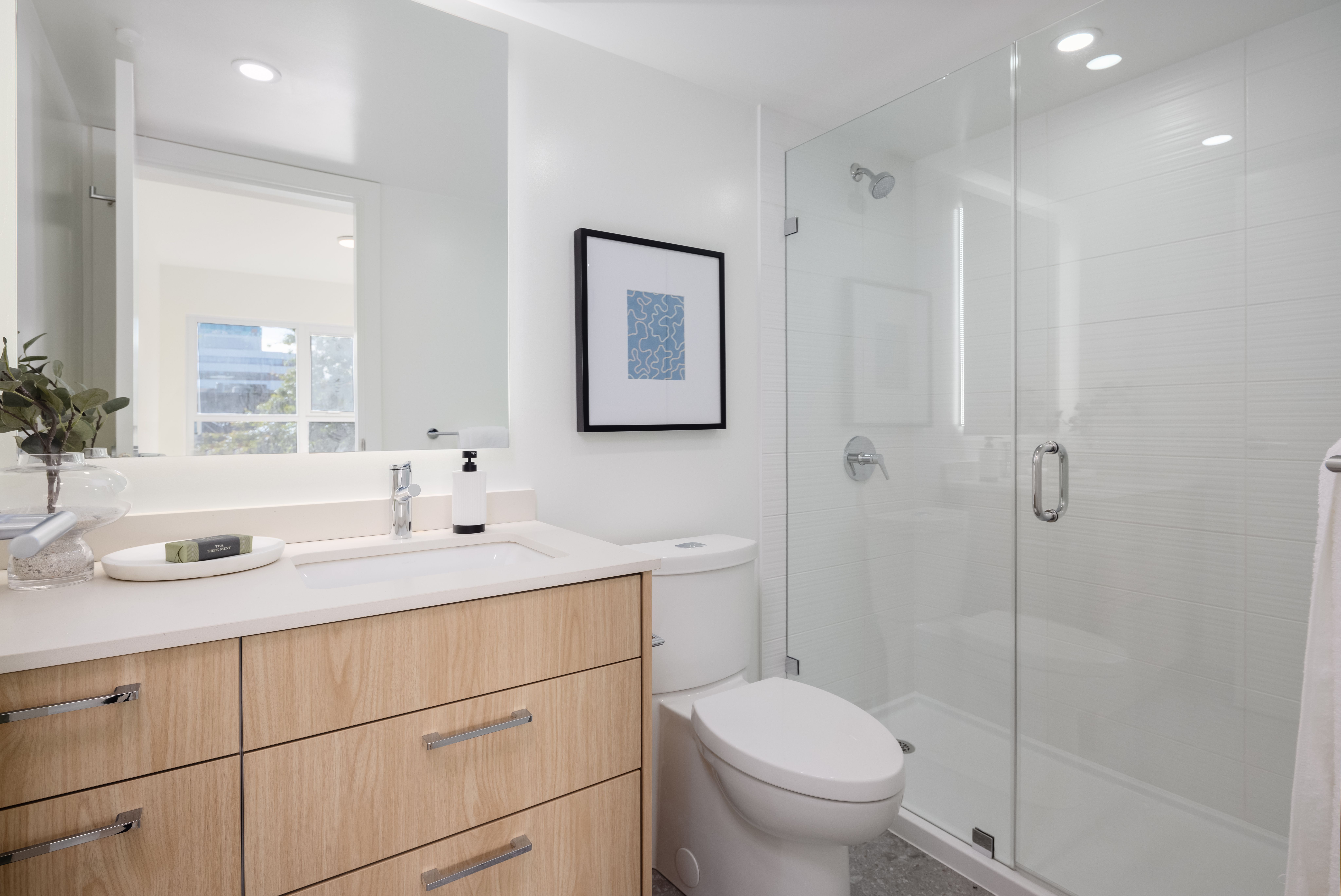 Restroom facilities with glass shower and modern feel