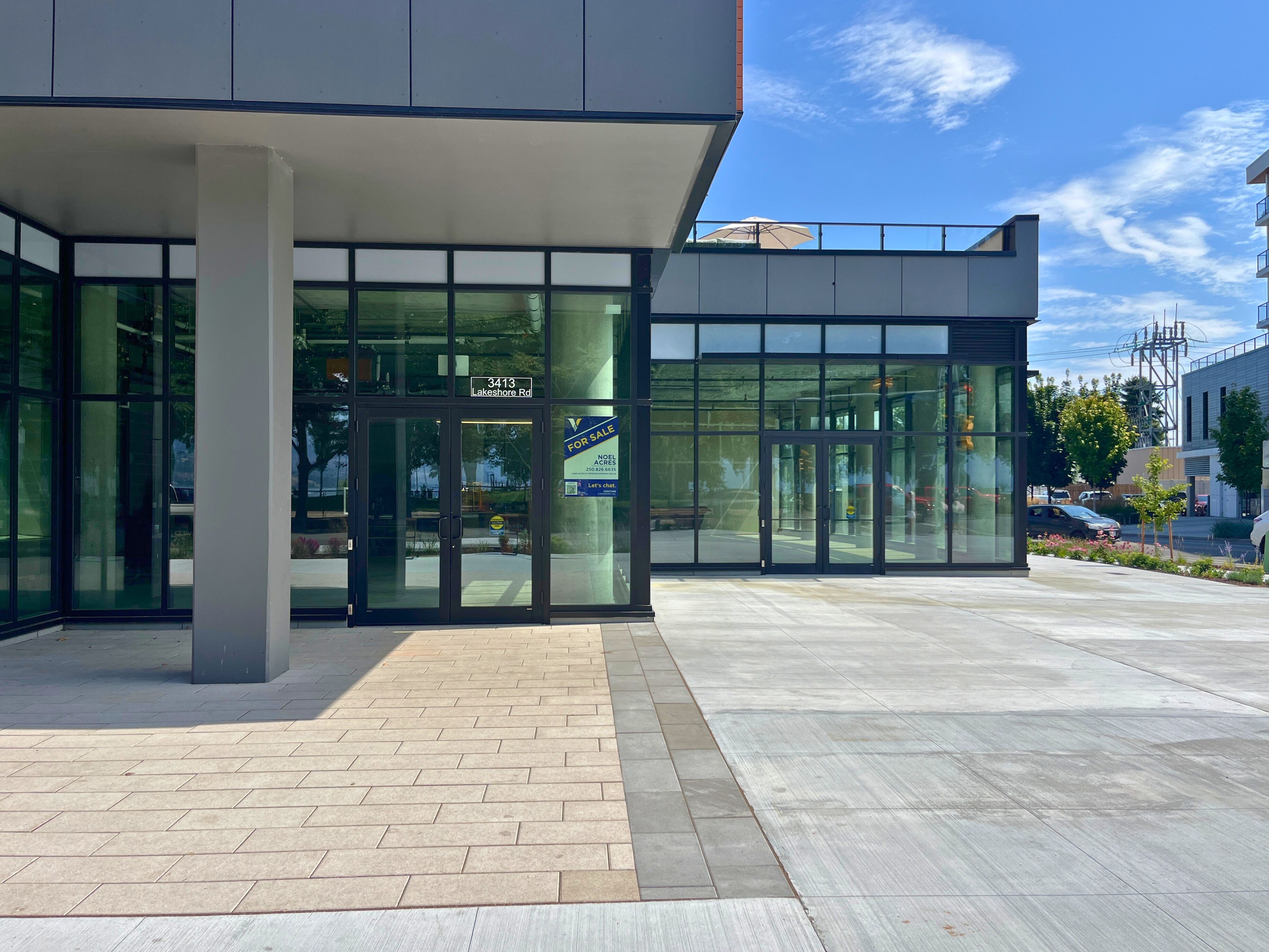 Patio area of a new, vacant commercial space on a sunny day