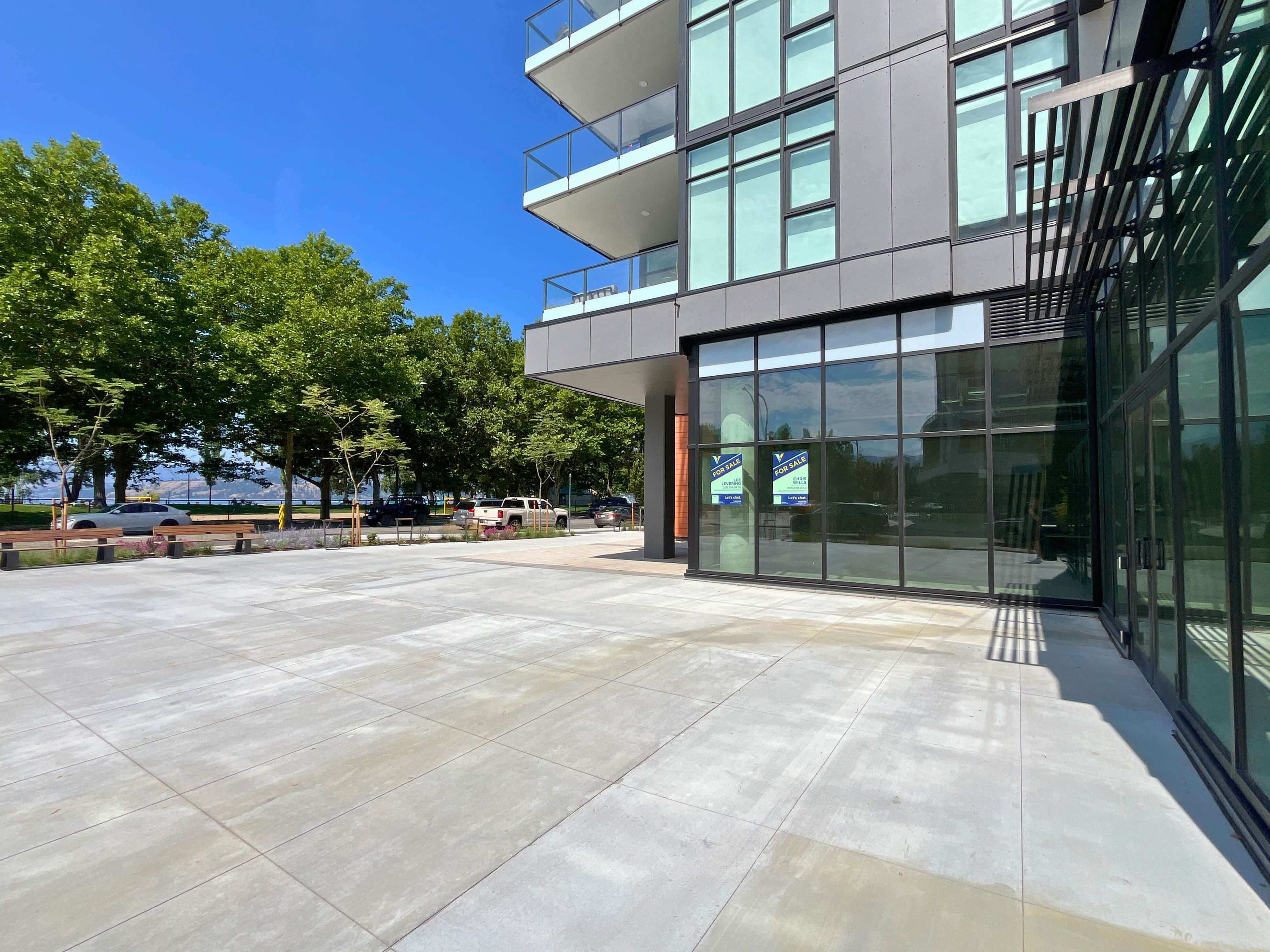 Sunshine on the expansive patio of a new, vacant commercial space across the street from a lush park