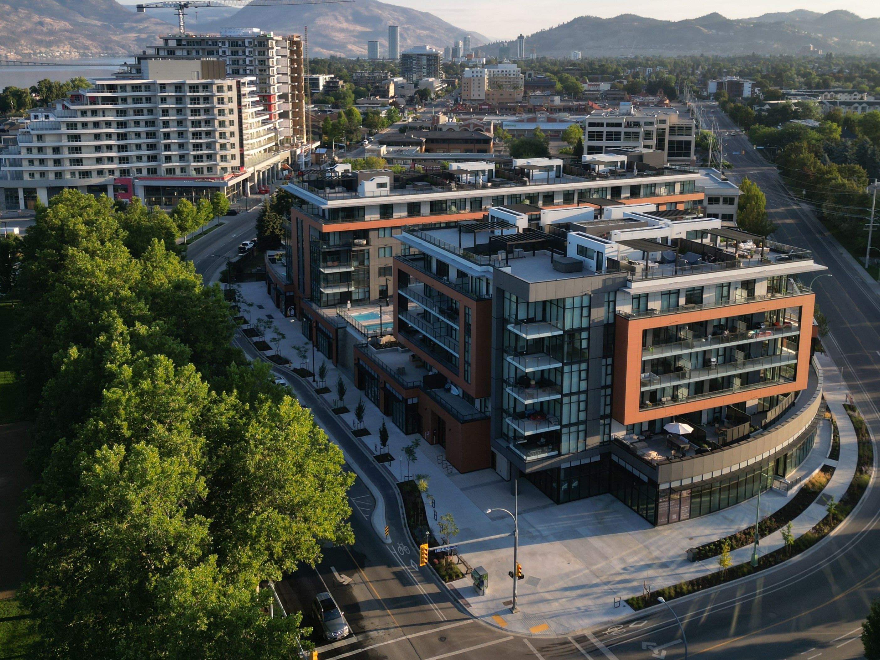 Aerial view of a new commercial and residential building across from a park