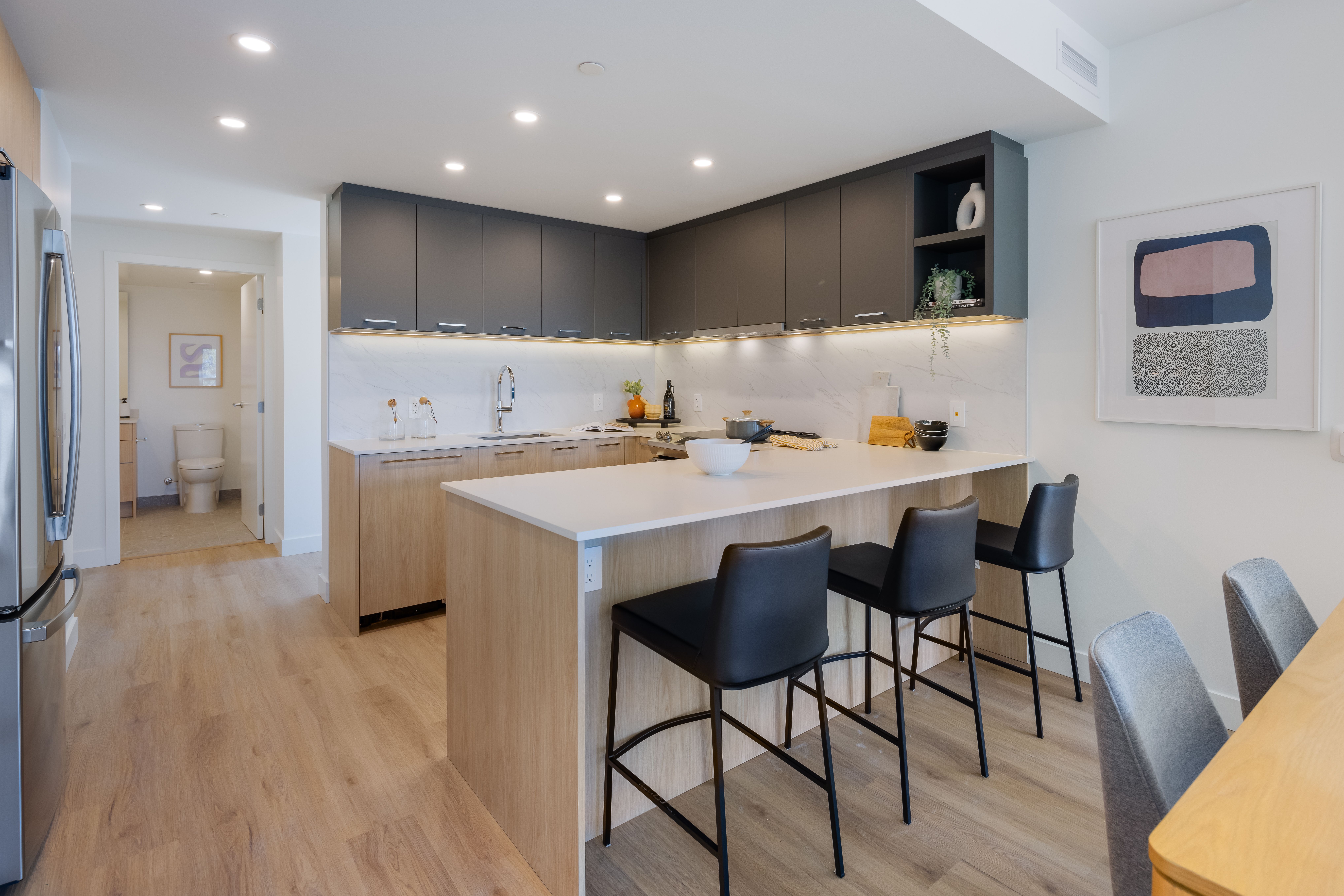 Near angle of modern kitchen with quartz countertops at Victor