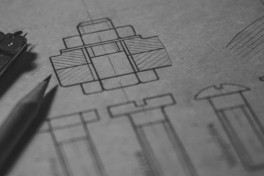 Technical blueprint drawings with drafting tools—planning, precision, and craft
