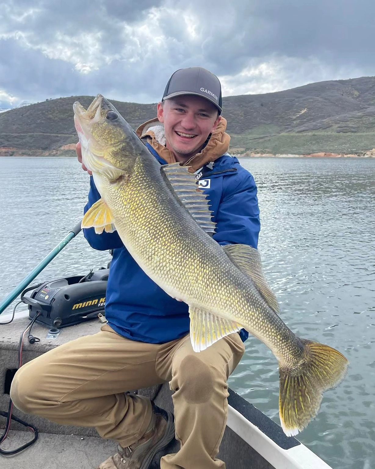 Wade holding a big fish in a boat