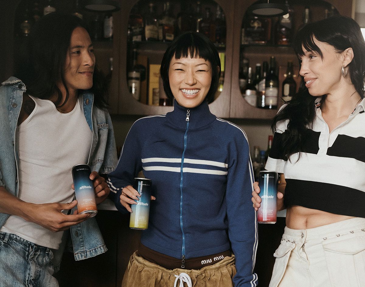Three people chatting holding Altitude