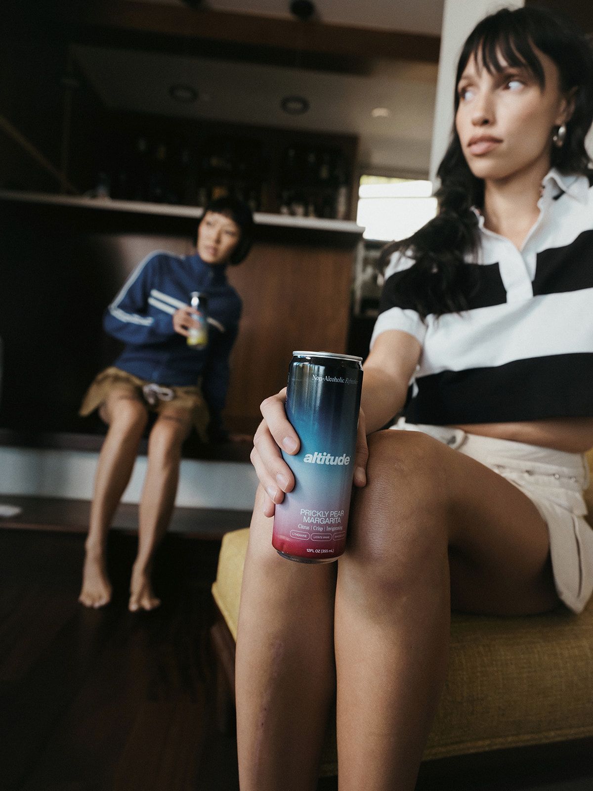 Two people sitting down and drinking Altitude