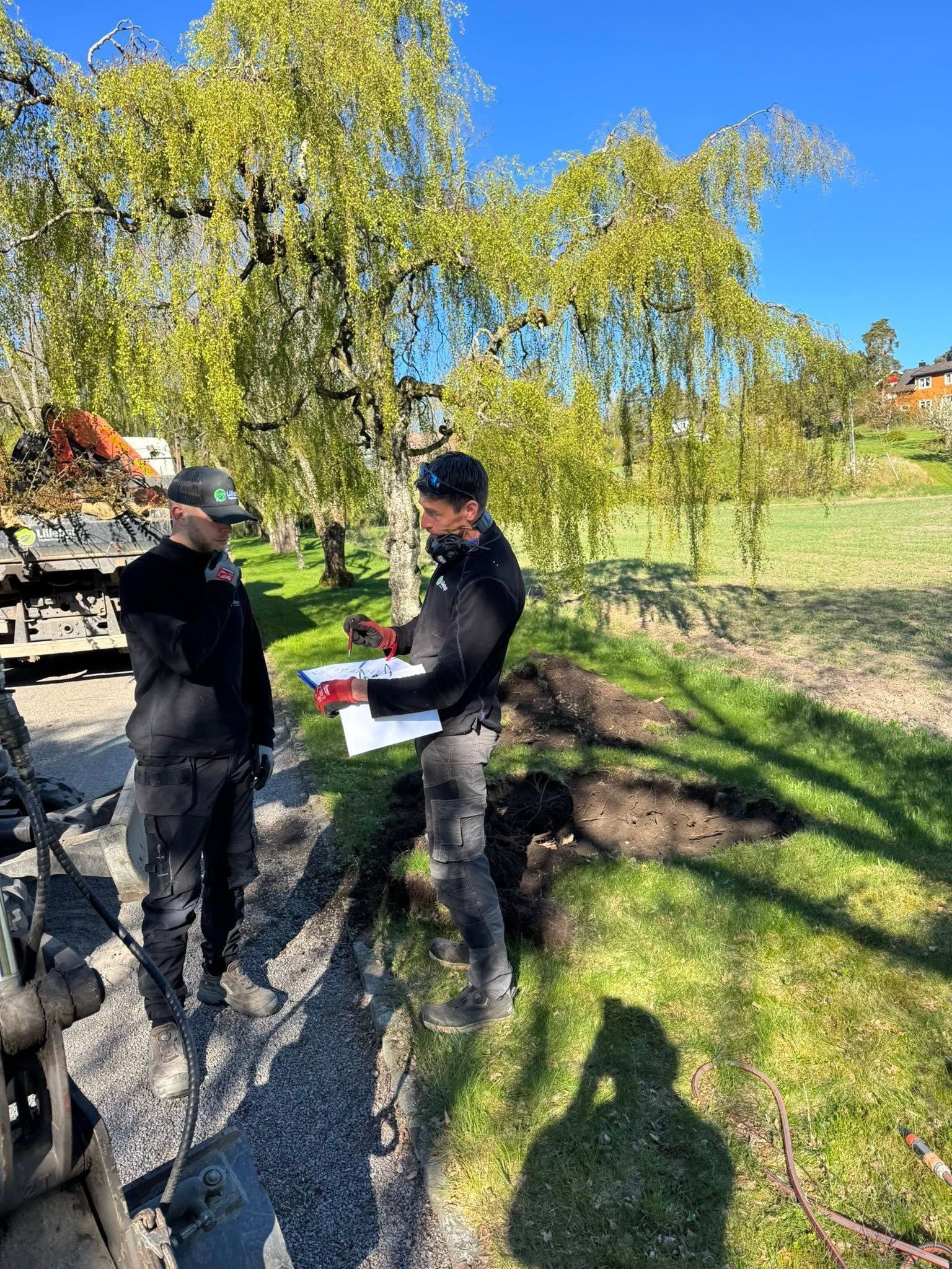 To fagfolk går befaring i en hage