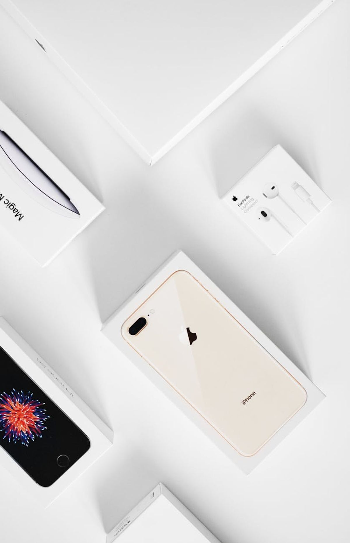 A clean and modern flat lay of gadgets in original packaging.