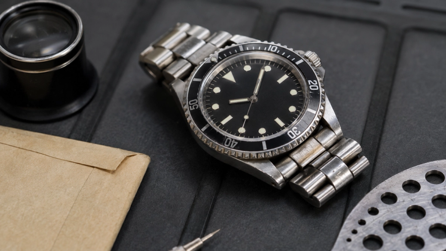 Pre-owned steel watch inspected for case condition, movement, bracelet and service history