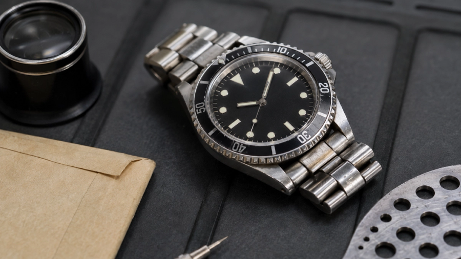 Pre-owned steel watch inspected for case condition, movement, bracelet and service history